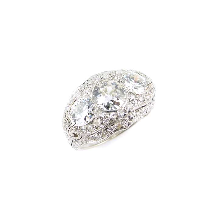 Antique three stone diamond and diamond cluster ring